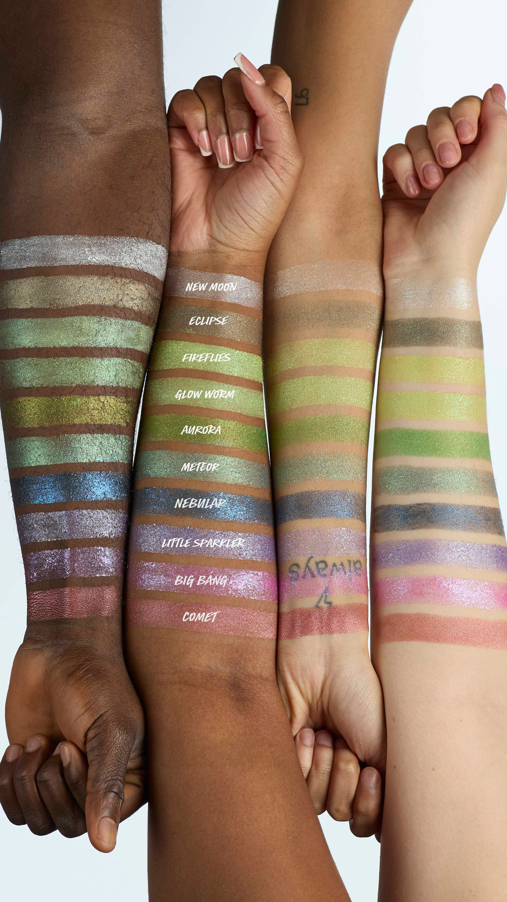 The image shows four model's forearms laid next to each other in varying shades of skin colour. There is a line of ten Glitter Crumble swatches across all four arms to showcase how each product colour shows up on different skin tones.